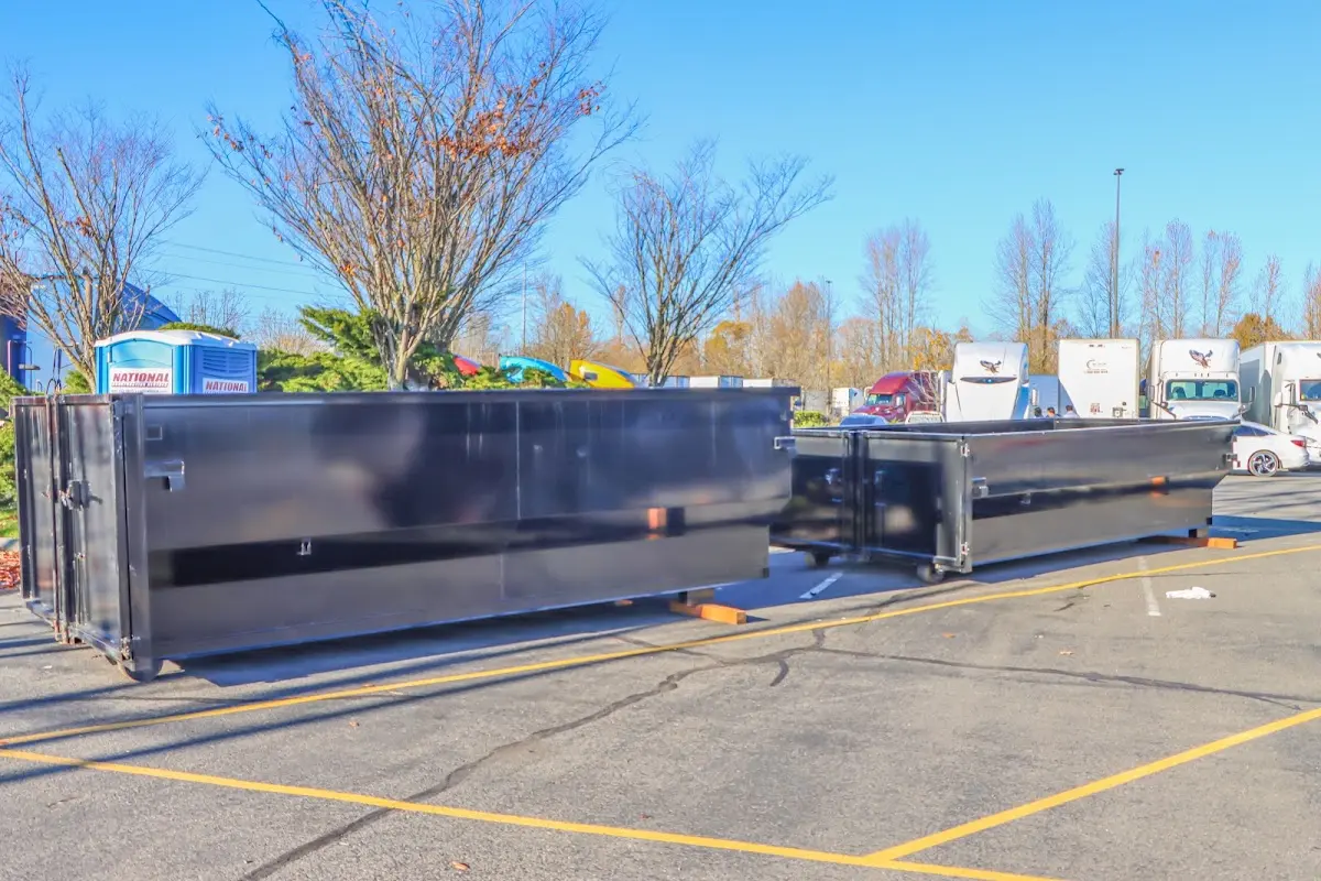 Professional dumpster rental service with roll-off container on residential driveway in Robbinsdale